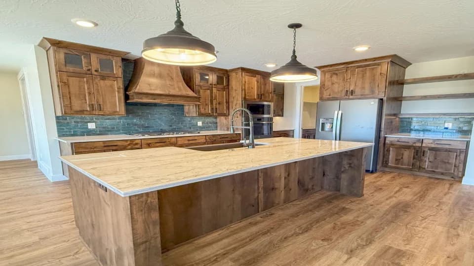 large kitchen with dark wood floors and turquoise tile backsplash