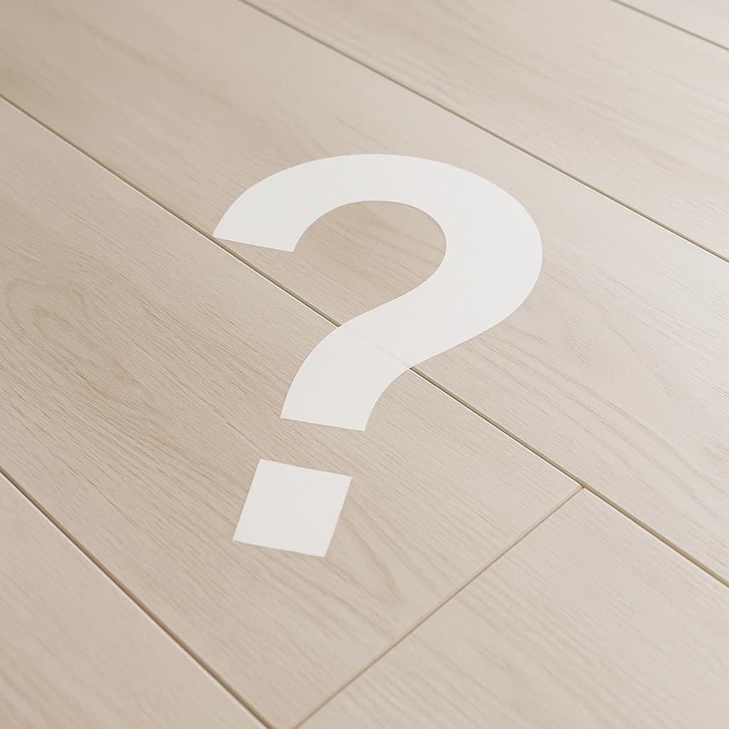 A white question mark on a tiled floor, symbolizing queries.